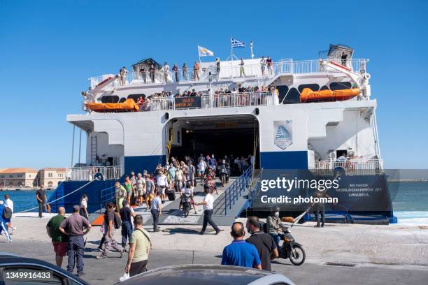 traveling people disembarking from greek seajets catamaran and waiting people - syros stock pictures, royalty-free photos & images