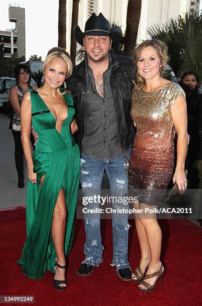 Co-Host Kristin Chenoweth, musician Jason Aldean, and Jessica Aldean arrive at the American Country Awards 2011 at the MGM Grand Garden Arena on...