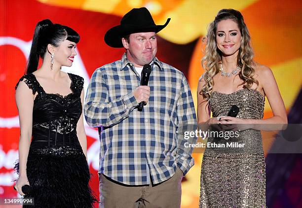 Musicians Susie Brown and Danelle Leverett of the Jane Dear Girls and musician Rodney Carrington speak onstage at the American Country Awards 2011 at...