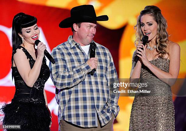 Musicians Susie Brown and Danelle Leverett of the Jane Dear Girls and musician Rodney Carrington speak onstage at the American Country Awards 2011 at...