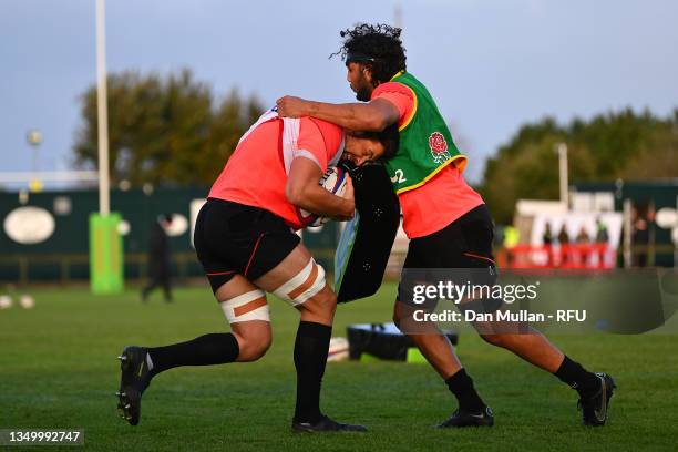 Charlie Ewels carries the ball into teammate Lewis Ludlam of England during a training session at Jersey Reds Rugby Club on October 29, 2021 in Saint...