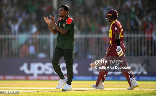 Mustafizur Rahman of Bangladesh celebrates the wicket of Dwayne Bravo of West Indies during the ICC Men's T20 World Cup match between West Indies and...