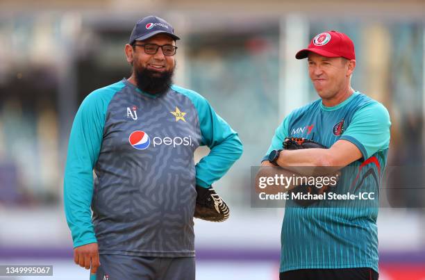 Saqlain Mushtaq, Coach of Pakistan interacts with Andy FLower, Coach of Afghanistan during the ICC Men's T20 World Cup match between Pakistan and...