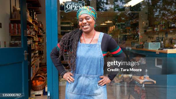 shop owner standing outside her business - black apron stock pictures, royalty-free photos & images