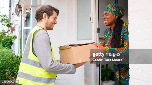 man delivering parcels to house - delivery character stock pictures, royalty-free photos & images