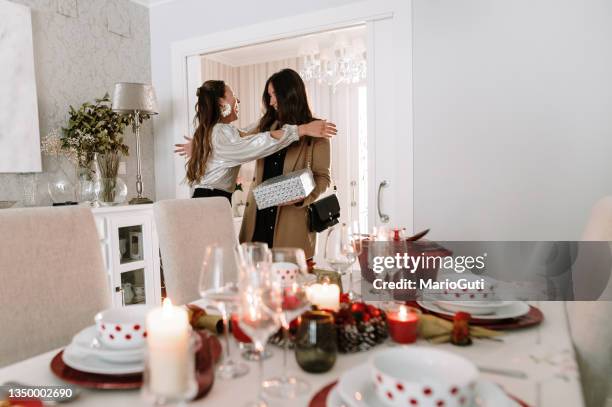 two embraced women on christmas - christmas guest stock pictures, royalty-free photos & images