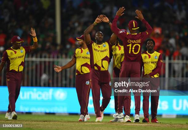 Andre Russell and Roston Chase of West Indies celebrates following the ICC Men's T20 World Cup match between West Indies and Bangladesh at Sharjah...