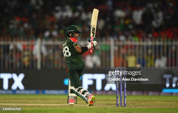Afif Hossain of Bangladesh plays a shot during the ICC Men's T20 World Cup match between West Indies and Bangladesh at Sharjah Cricket Stadium on...