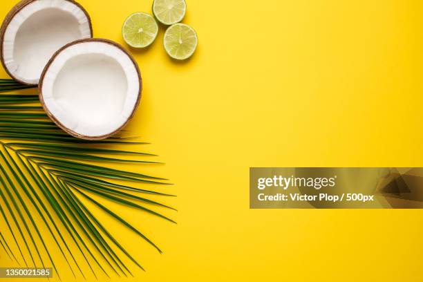 high angle view of coconut on yellow background - lemon lime top stock pictures, royalty-free photos & images