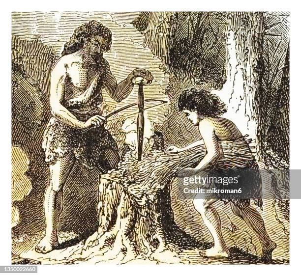 old engraved illustration of prehistoric man (savage) of the stone age - lighting a fire - prehistoric people stock pictures, royalty-free photos & images