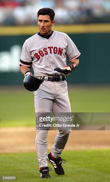 Shortstop Nomar Garciaparra of the Boston Red Sox removes his helmet at the end of an inning during the MLB game against the Seattle Mariners on...