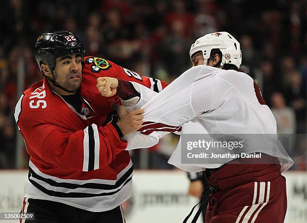 Jamal Mayers of the Chicago Blackhawks fights with Kyle Chipchura of the Phoenix Coyotes in the second period at the United Center on December 5,...