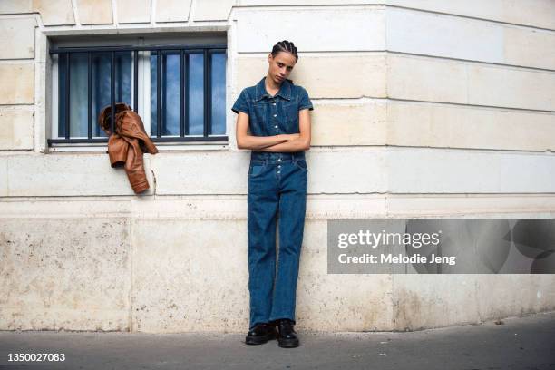 Model Alyssa Sardine wears a denim jumpsuit and black boots after the Rochas show on September 29, 2021 in Paris, France.