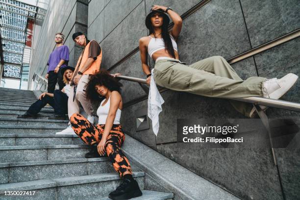young adult dancers in the city on a modern staircase - rap group stockfoto's en -beelden