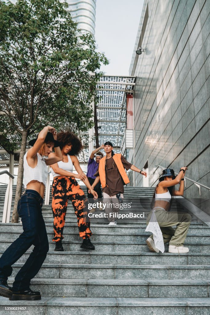 Young adult dancers in the city on a modern staircase