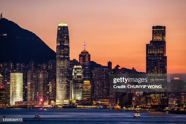 hong kong neon sunset iconic harbour skyscrapers - tsim sha tsui stock pictures, royalty-free photos & images