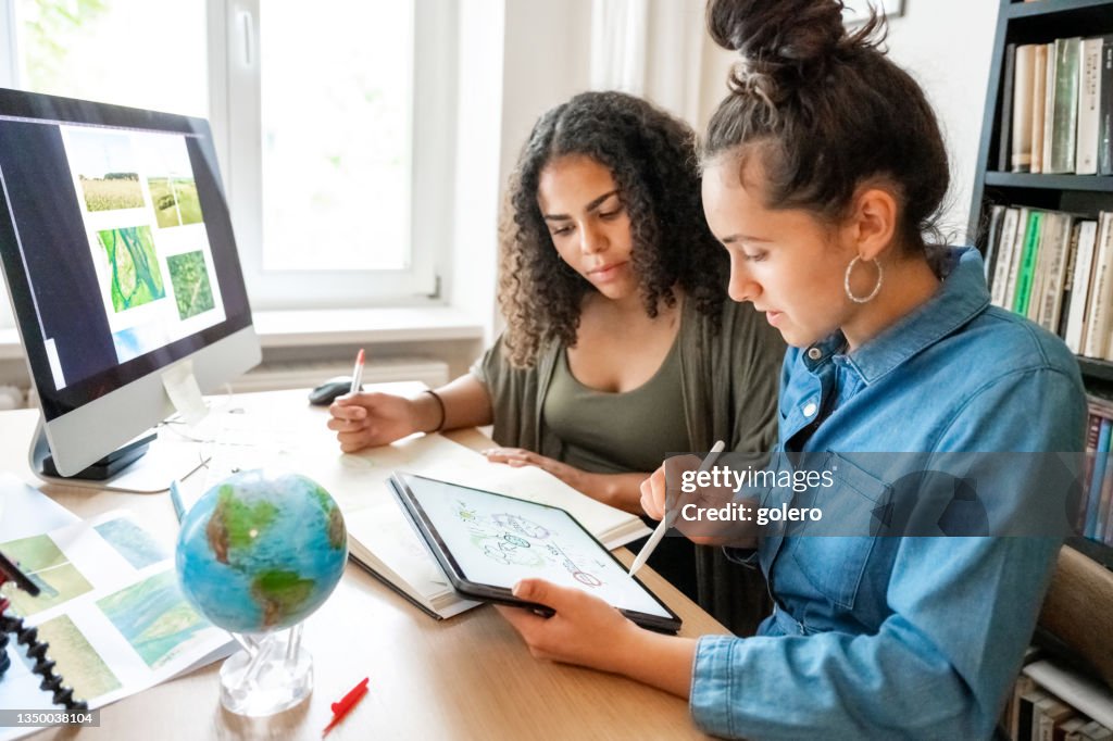 Two young woman working together on concepts for climate protection