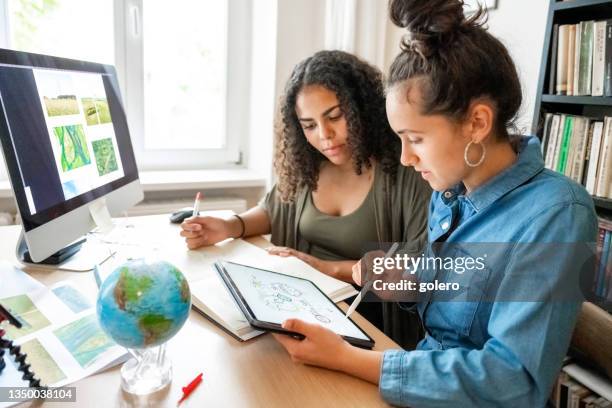 two young woman working together on concepts for climate protection - klimat bildbanksfoton och bilder