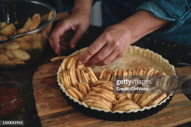 preparing apple pie in domestic kitchen - apple pie stock pictures, royalty-free photos & images