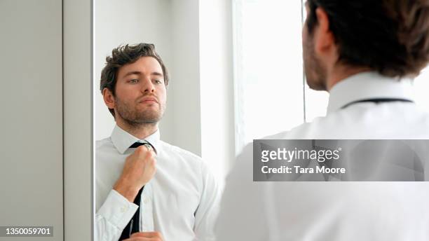 young man getting dressed - business suit tie stock-fotos und bilder