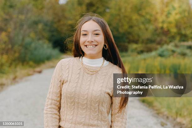 beautiful teenager girl smiling at the camera while in nature - mock turtleneck stock-fotos und bilder