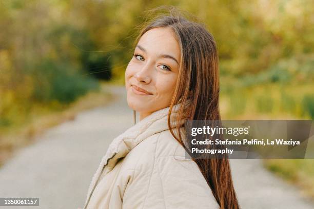 beautiful teenager girl smiling at the camera while in nature - green eyes stock pictures, royalty-free photos & images