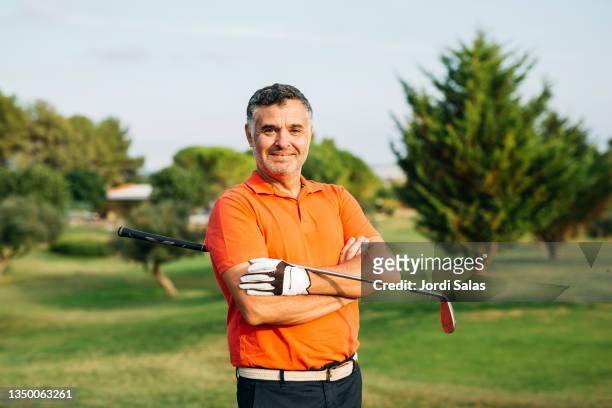portrait of a golfer in a golf course - golfer stock pictures, royalty-free photos & images
