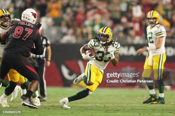 Running back Aaron Jones of the Green Bay Packers rushes the football during the NFL game at State Farm Stadium on October 28, 2021 in Glendale,...