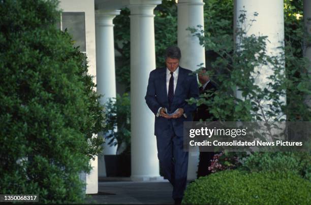 President Bill Clinton reviews his notes prior a press conference in the White House's Rose Garden, Washington DC, May 13, 1994.