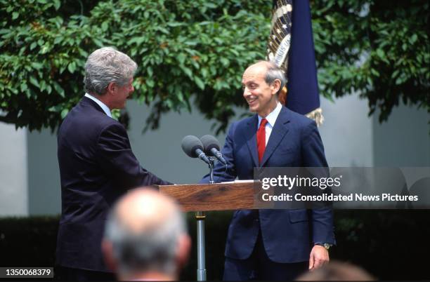 President Bill Clinton shakes hands with US Court of Appeals Chief Judge Stephen Breyer during a press conference in the White House's Rose Garden,...