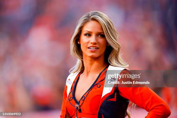 Denver Broncos cheerleader looks on from the field during the second half of a game against the Las Vegas Raiders at Empower Field at Mile High on...