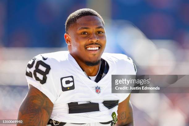Running back Josh Jacobs of the Las Vegas Raiders warms up before a game against the Denver Broncos at Empower Field at Mile High on October 17, 2021...