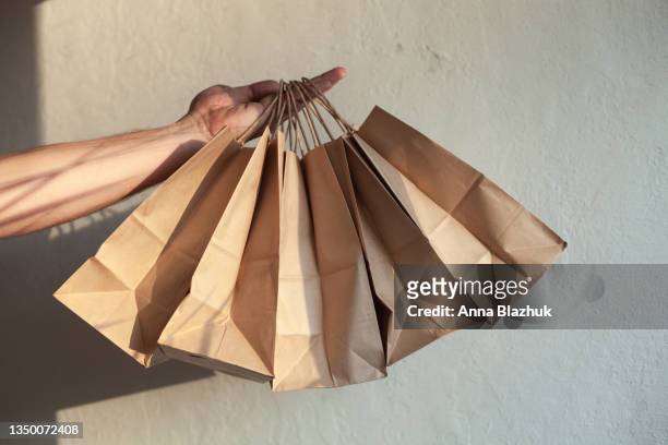 paper shopping bags in hand. concept of sale and black friday, cyber monday. - cyber monday stock-fotos und bilder