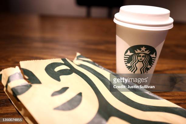 The Starbucks logo is display on a cup and bag at a Starbucks store on October 29, 2021 in San Francisco, California. Starbucks shares fell 7 percent...