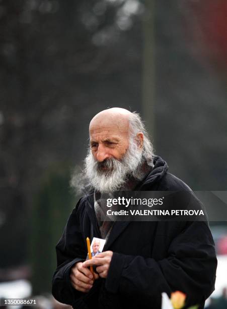 Supporter of late former Yugoslav President Slobodan Milosevicas holds his idol's picture in front of the Museum of the Revolution in Belgrade, 17...