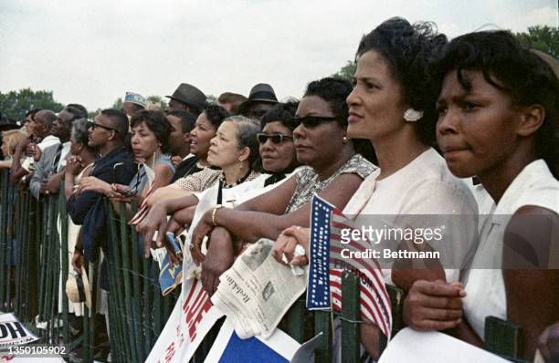 View of participants in the March on Washington, some with America flags, Washington DC, August 28, 1963. More than two-hundred thousand people...