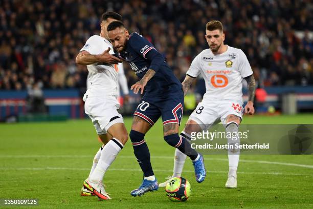 Neymar of Paris Saint-Germain takes on Zeki Celik of Lille and Xeka of Lille during the Ligue 1 Uber Eats match between Paris Saint Germain and Lille...