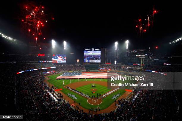 The United States flag is displayed in the outfield as Zac Brown performs the national anthem prior to Game Three of the World Series between the...