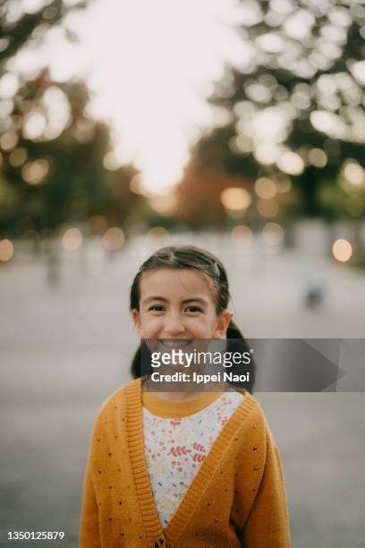 cute mixed race girl smiling at camera at dusk, tokyo - eurasische herkunft stock-fotos und bilder