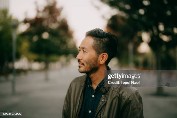 handsome japanese man at dusk, tokyo - 40代 男性 ストックフォトと画像