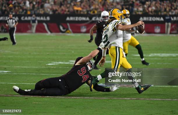 Zach Allen of the Arizona Cardinals tackles Aaron Rodgers of the Green Bay Packers at State Farm Stadium on October 28, 2021 in Glendale, Arizona....