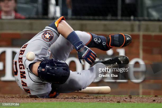Alex Bregman of the Houston Astros is hit by the pitch against the Atlanta Braves during the sixth inning in Game Three of the World Series at Truist...