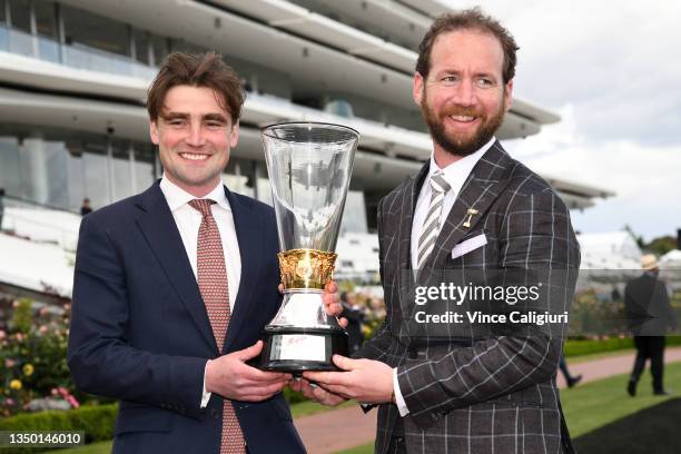 Trainers David Eustace and Ciaron Maher of Hitotsu, pose with the Victoria Derby trophy after jockey John Allen won race 6, the Penfolds Victoria...