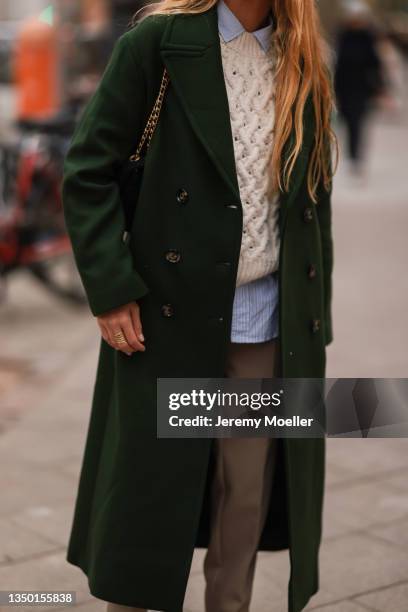 Blanca Miro wearing a Mango green coat, a white pullover and blue shirt, a beige pants on October 27, 2021 in Berlin, Germany.