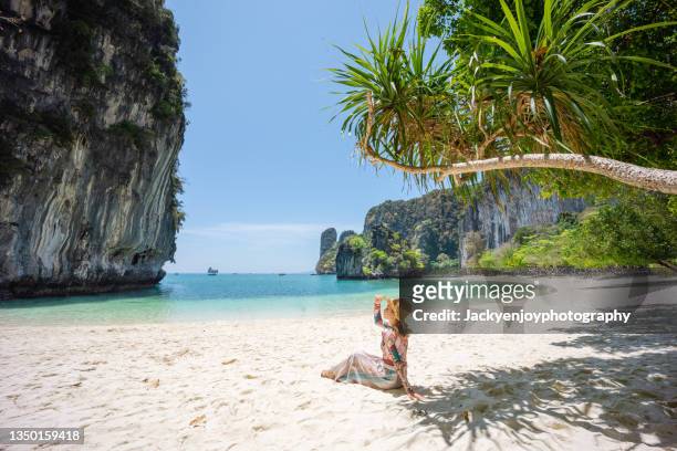 a tourist girl on koh hong beach in the morning clear sky, krabi province, thailand. - thailand strand stock-fotos und bilder