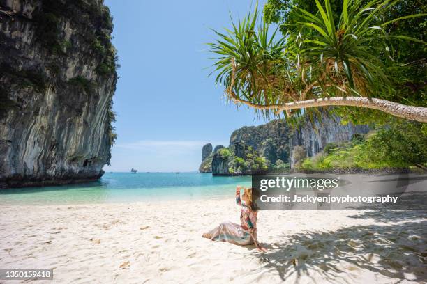 a tourist girl on koh hong beach in the morning clear sky, krabi province, thailand. - phuket - fotografias e filmes do acervo