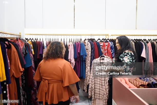 business owner helping a customer in her fashion boutique - plus size fashion stock pictures, royalty-free photos & images