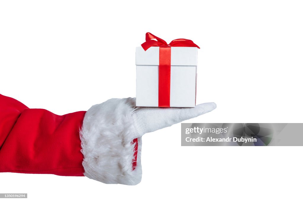 Hand of sanat claus giving a gift on white background with copy space isolate.
