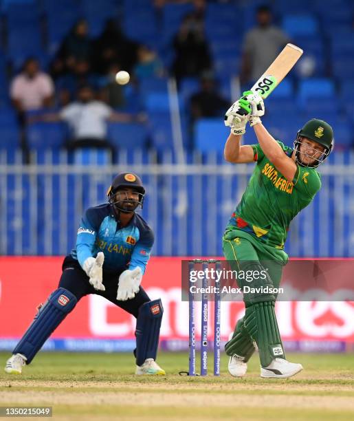 David Miller of South Africa plays a shot as Kusal Perera of Sri Lanka looks on during the ICC Men's T20 World Cup match between South Africa and Sri...