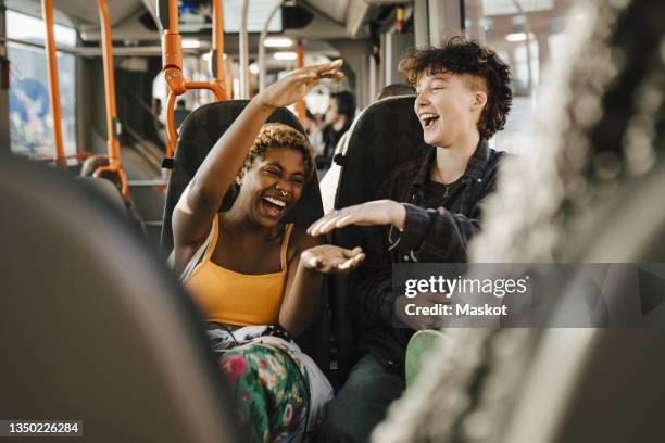 cheerful multiracial friends traveling in bus - bus photos et images de collection